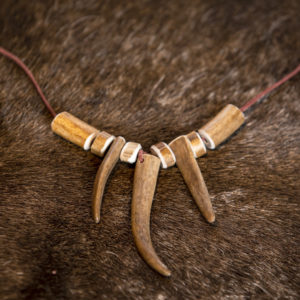 9-part reindeer pendant. Woven leather ribbon 85 cm, reindeer horn.